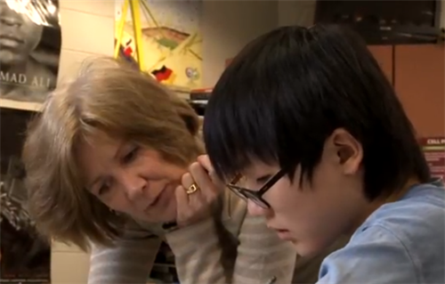 Teacher working with student individually 